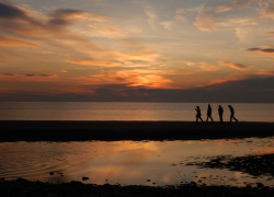 People walking in sunset Sunset Allonby